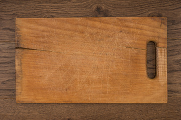 Empty vintage cutting board on planks food background concept