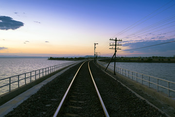 Fototapeta na wymiar the track of railway or railroad with the morning twilight sky before the sunrise