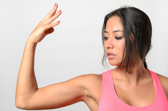 Pretty young woman making a graceful arm gesture