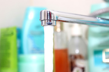 Close-up water tap. Working water tap.