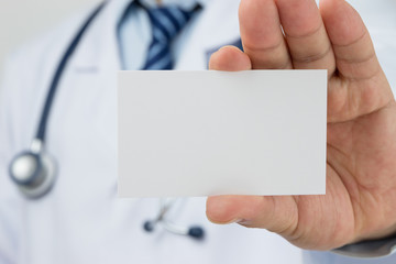 Doctors hand holding a business card
