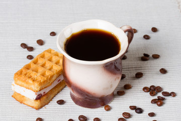 Cup of coffee, waffles and coffee beans