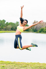 Young Woman Fitness Trainer Leaping