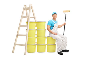 Decorator sitting on a pile of color buckets