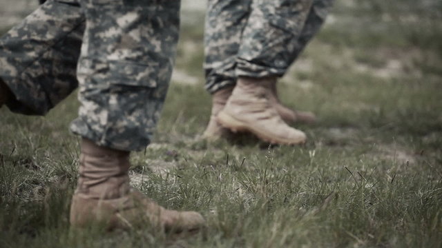 Soldiers' boots walking across the field
