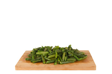 Green string beans on a wooden board