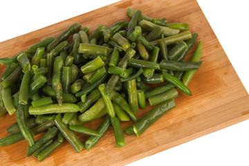 Green string beans on a wooden board