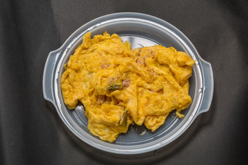 Pork omelet on a plastic plate