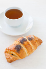 Fresh and tasty croissant and hot tea
