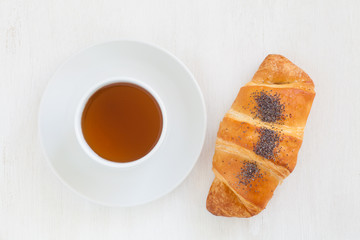 Fresh and tasty croissant and hot tea