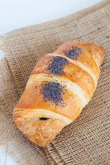 Fresh and tasty croissant over white background