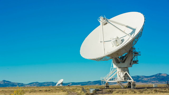 Satellite Array Turns Slowly Towards. a satellite from the Ver Large Array in New Mexico turns slowly towards the camera
