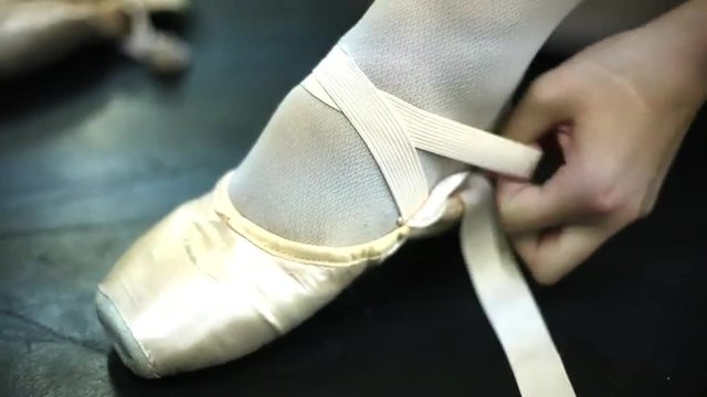 Closeup of a woman donning her slippers.