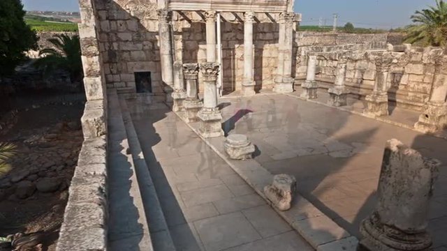 Dolly time-lapse of tourists at the old synagogue in Capernuam, Israel