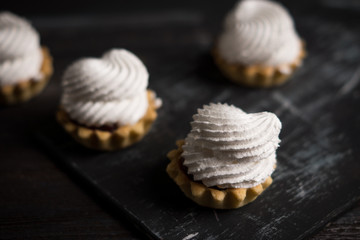 Creamy cake on the dark rustic background. Shallow depth of field.