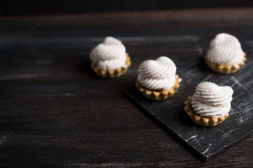 Creamy cake on the dark rustic background. Shallow depth of field.