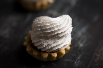Creamy cake on the dark rustic background. Shallow depth of field.