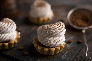 Creamy cake on the dark rustic background. Shallow depth of field.