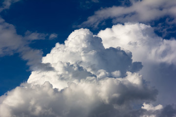 Naklejka na ściany i meble Large cumulus clouds against a bright blue sky closeup