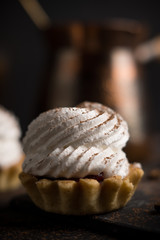 Creamy cake on the dark rustic background. Shallow depth of field.