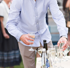 Wedding guest holding glass of champagne closeup