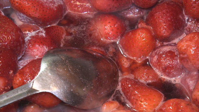 Tablespoon and strawberry in the pan