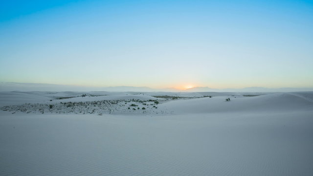White Sands Wide Dunes in Windy Condition. a wide shot of the white sand dunes in New Mexico during windy conditions at sunset
