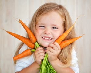 Beautiful little girl with a fresh carrot © nuzza11