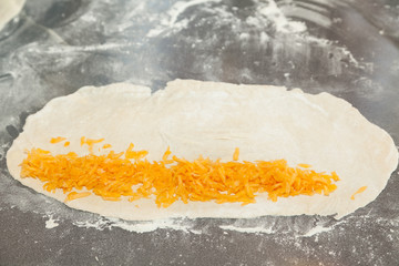 rolled dough with grated pumpkin and sugar