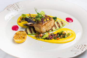 Grilled fish, on white plate