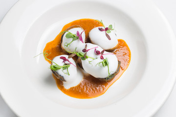 Vintage plate with black homemade ravioli  salted salmon