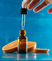 essential oil bottle with orange slices and dropper - 100139577