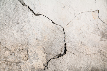 Crack. Texture of old painted white plaster. Cracked wall.