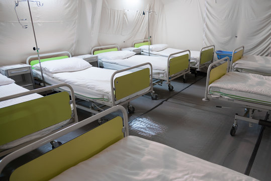 Field hospital tent with beds.