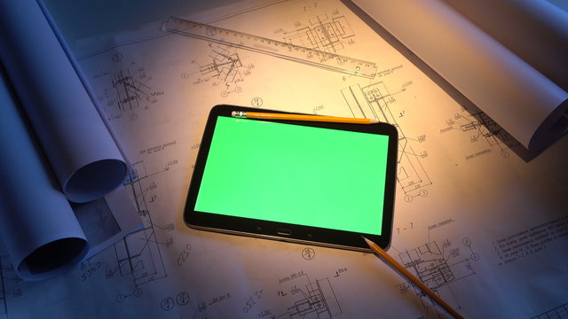 green screen. tablet PC lays on the drawing.