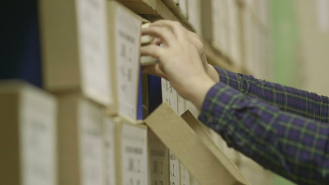 Man looking documents in the archive