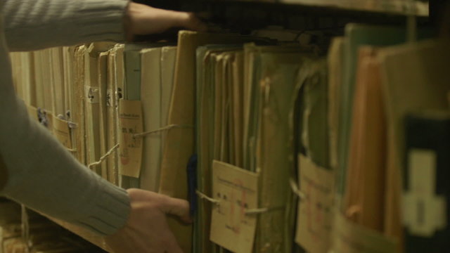 Man looking documents in the archive