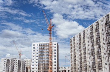 Fototapeta na wymiar Construction cranes and new high-rise buildings