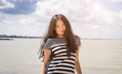 Attractive asian girl at the beach - people, lifestyle concept