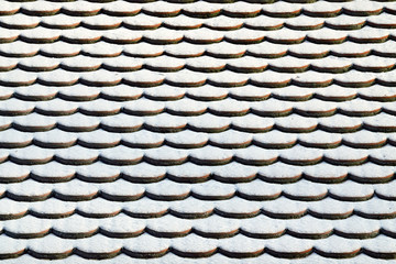 Tile roof in the snow. Winter background