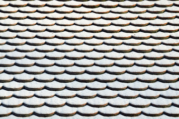 Tile roof in the snow. Winter background