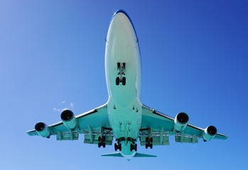 A jumbo jet airplane flying low over water
