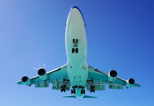 A Jumbo Jet Airplane Flying Low Over Water