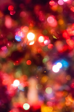 Colorful bokeh on a Christmas tree; background type vertical image