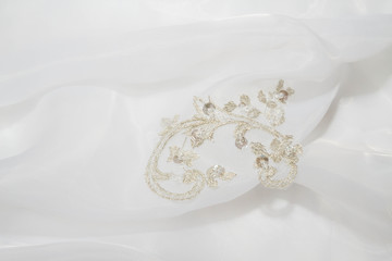 Embroidery with stones on a white wedding dress