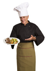 Chef holding plate with roasted meat