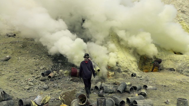 Ijen volcano crater, workers dig sulfur in extreme conditions, slow motion
