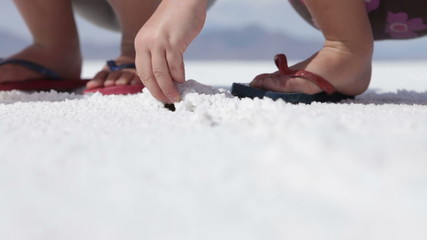 Children digging in salt flats - Powered by Adobe