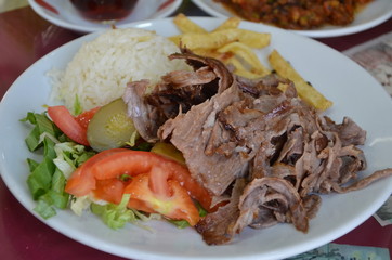 Donner kebab and chips served with salad and steamed rice - traditional turkish dish