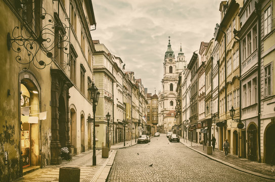 View to the street in the old center of Prague - the capital and largest city of the Czech Republic - vintage sepia retro travel background